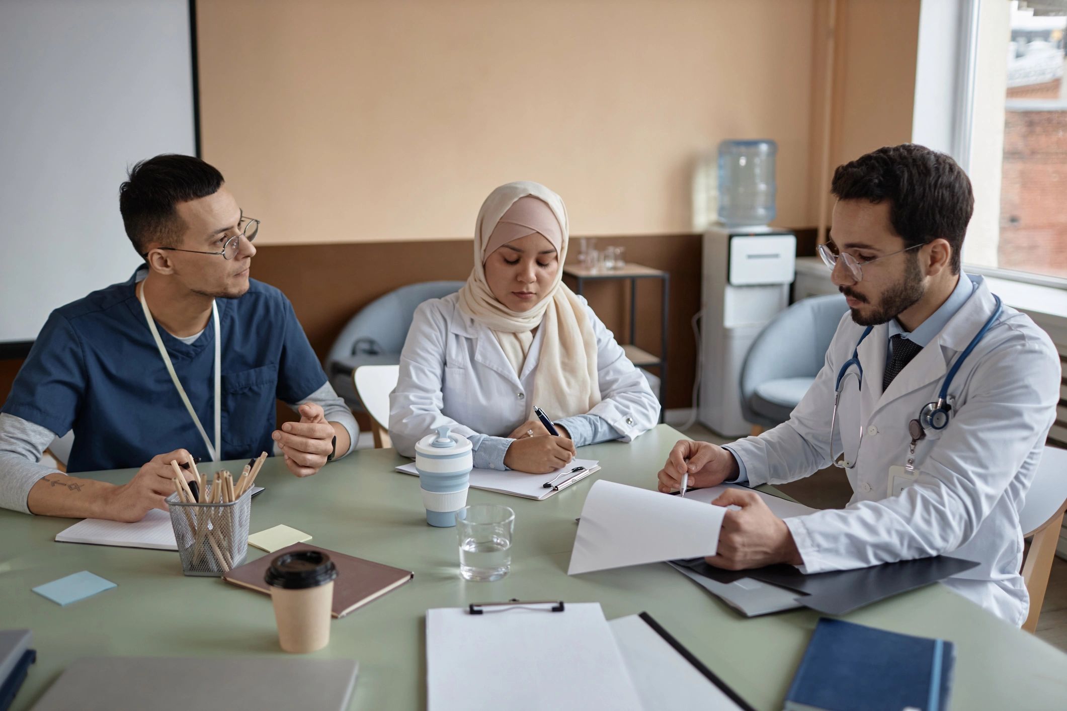 Medical specialists reviewing documents in a meeting