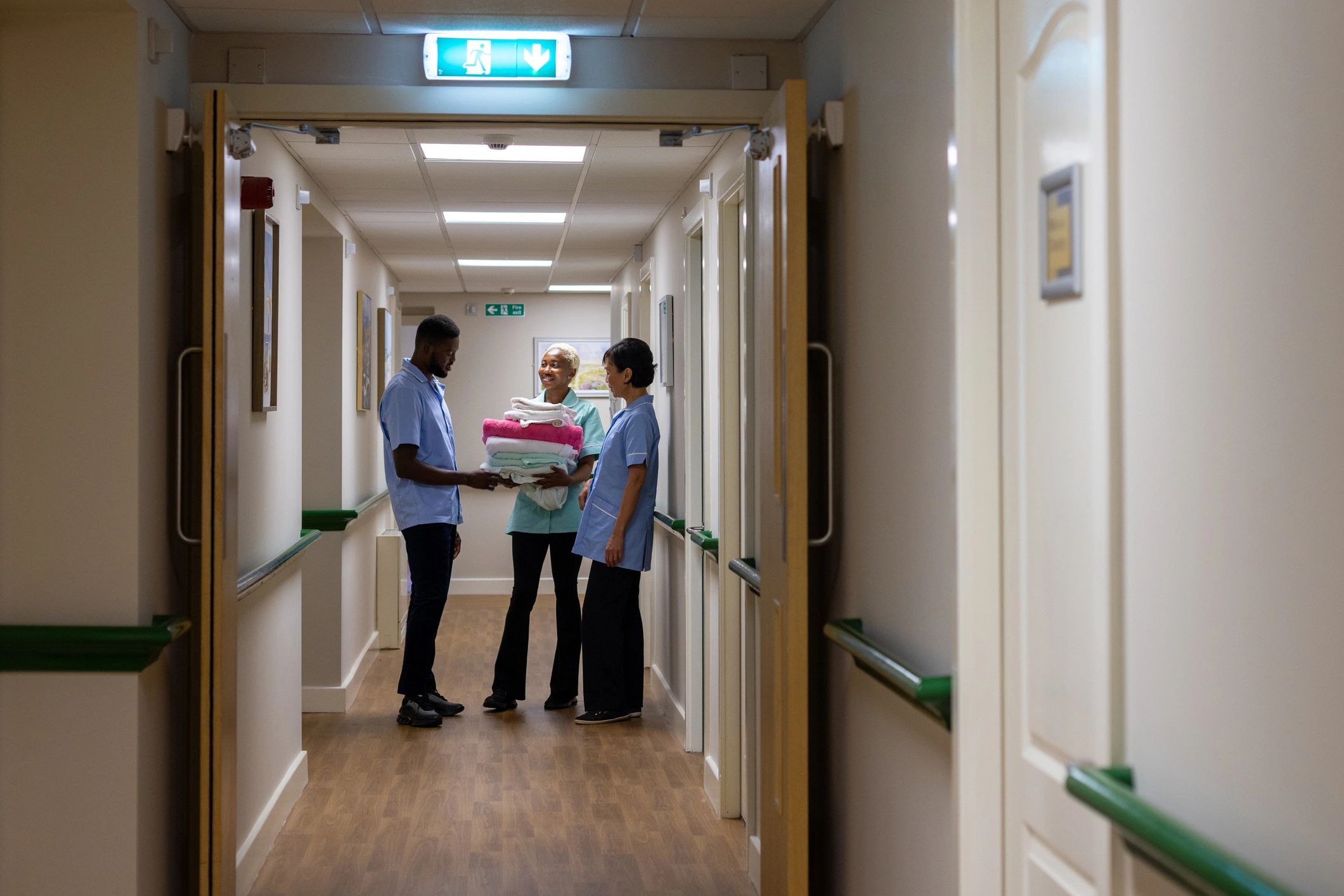 Healthcare workers talking in corridor