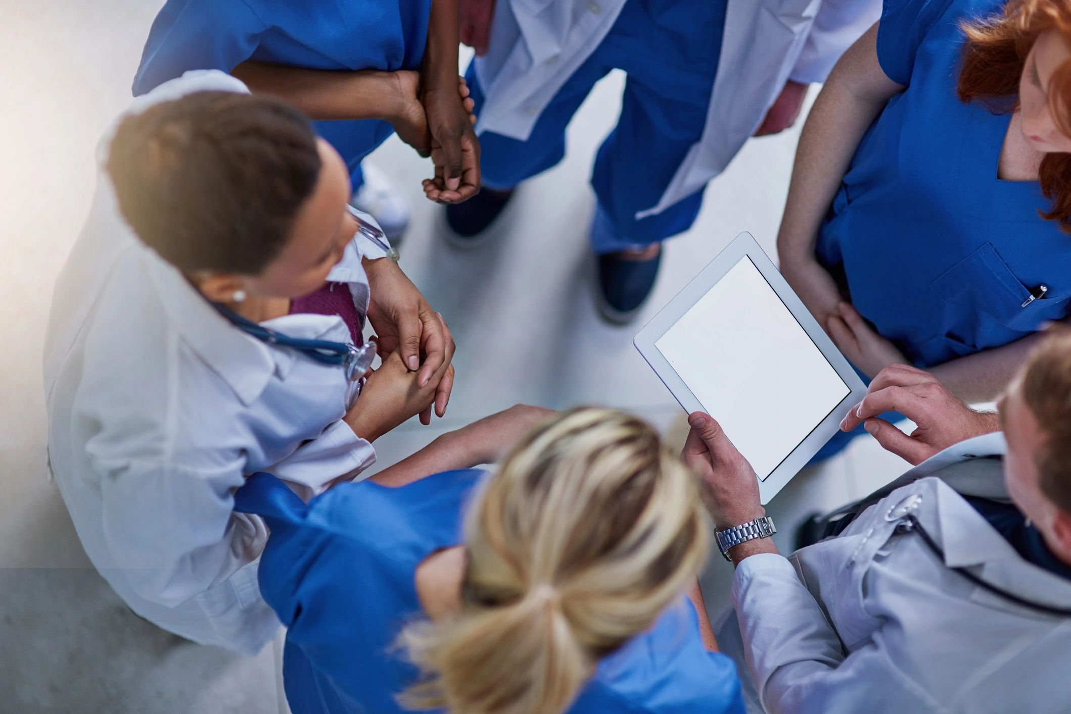 Medical team reviewing information together on a tablet