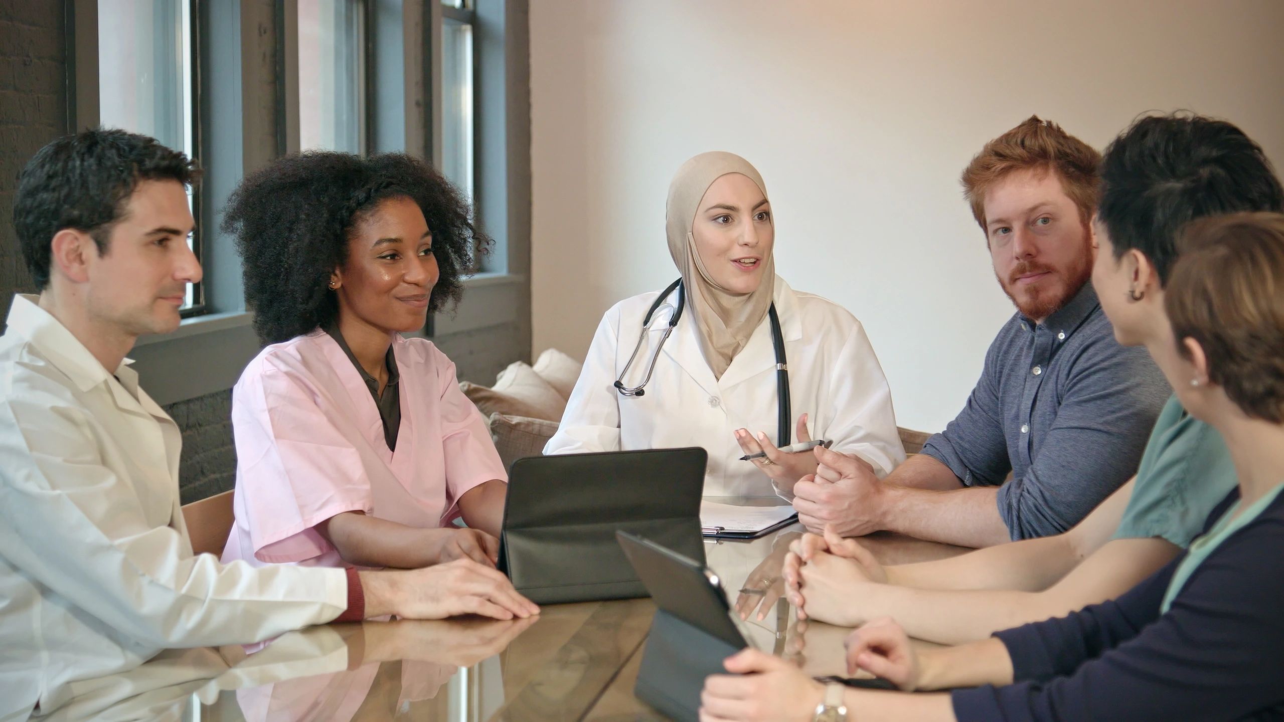 Healthcare leadership team meeting in a modern office